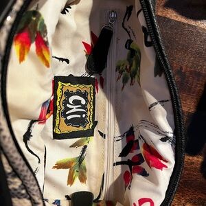 Chi bag with faux snake skin andblack outer panel